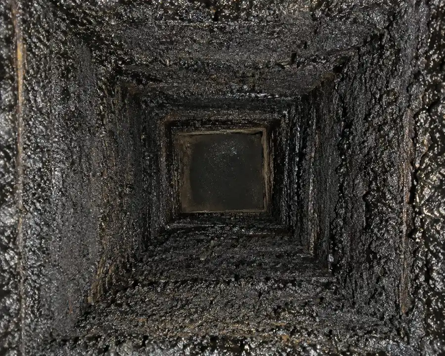 View up a blocked, sooty Sydney chimney flue in need of clearing